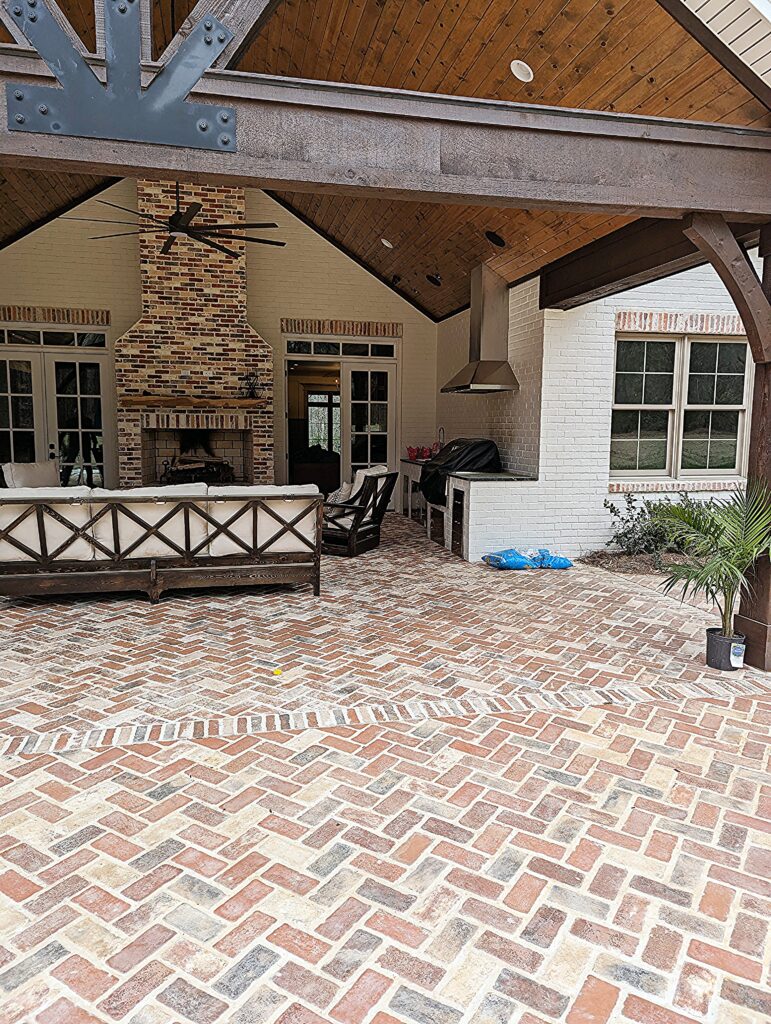 Patriot Pavers thin brick on a large patio and covered porch and firepace chimney.
